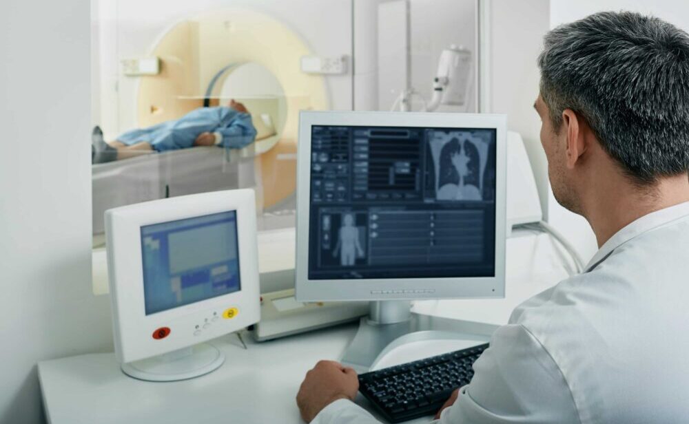doctor looking over CT scan, cancer misdiagnosis