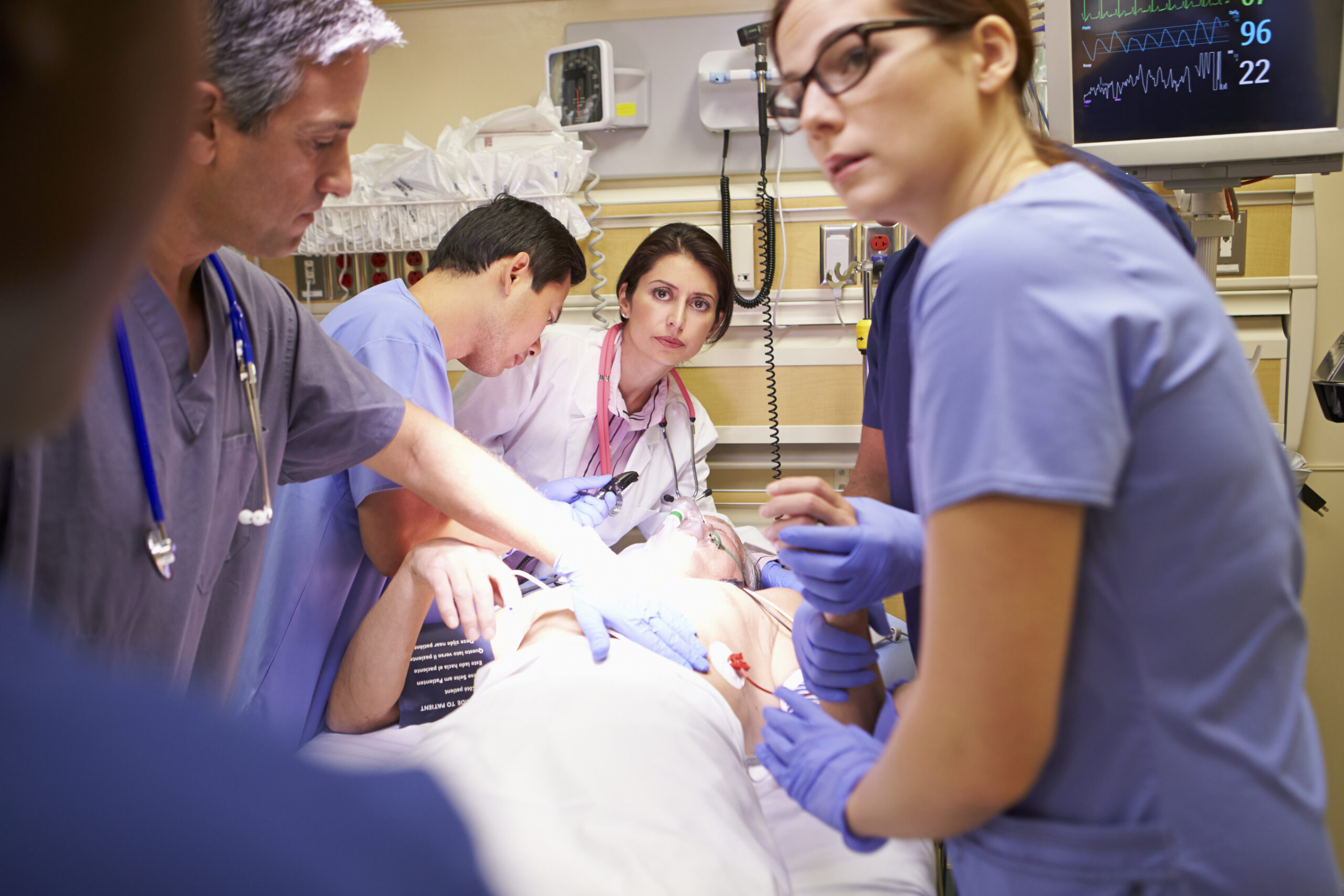 team of doctors working on patient